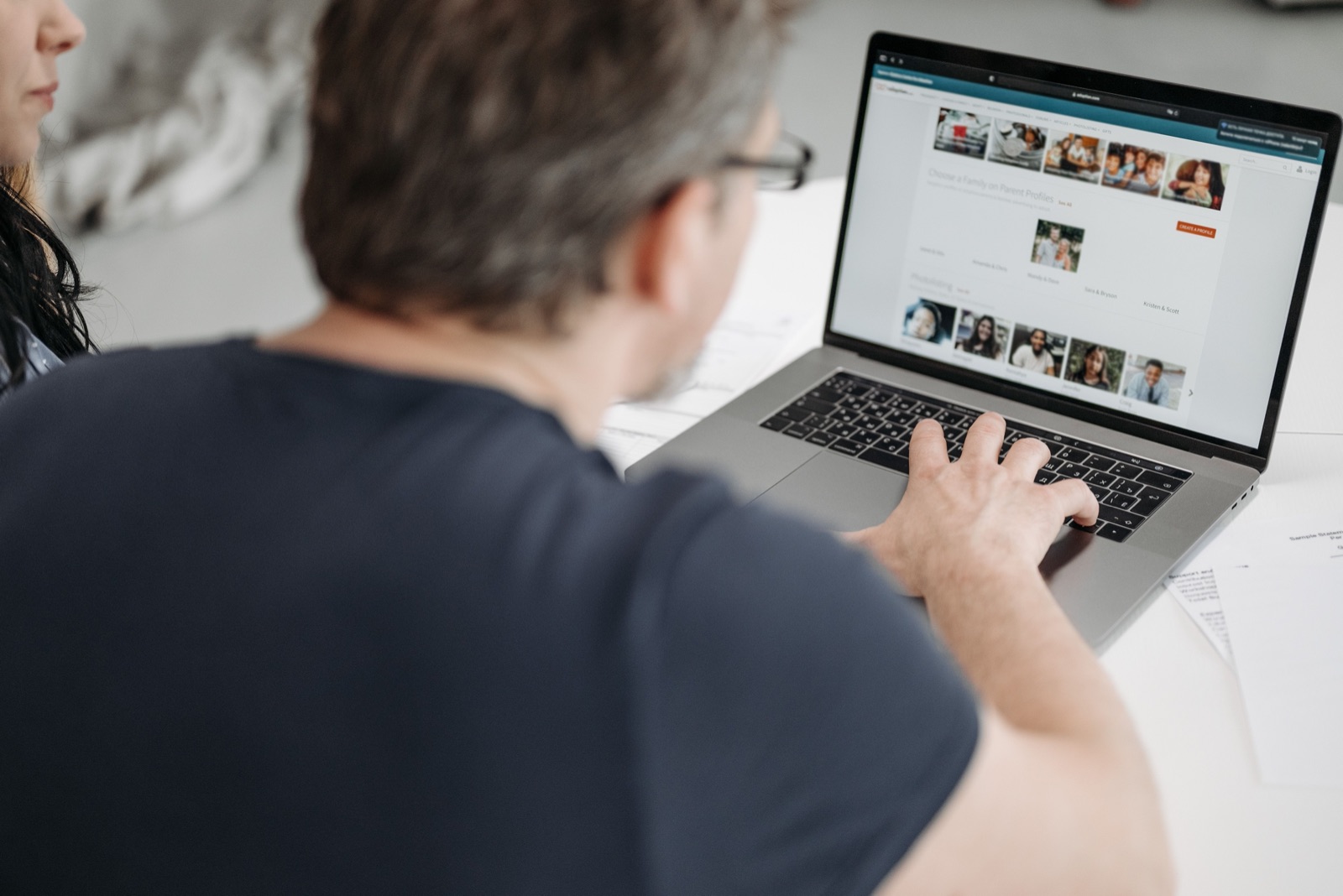 Person browsing flatmate profiles on a laptop